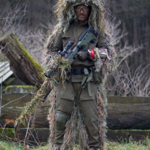 soldier covered with grass holding sniper rifle